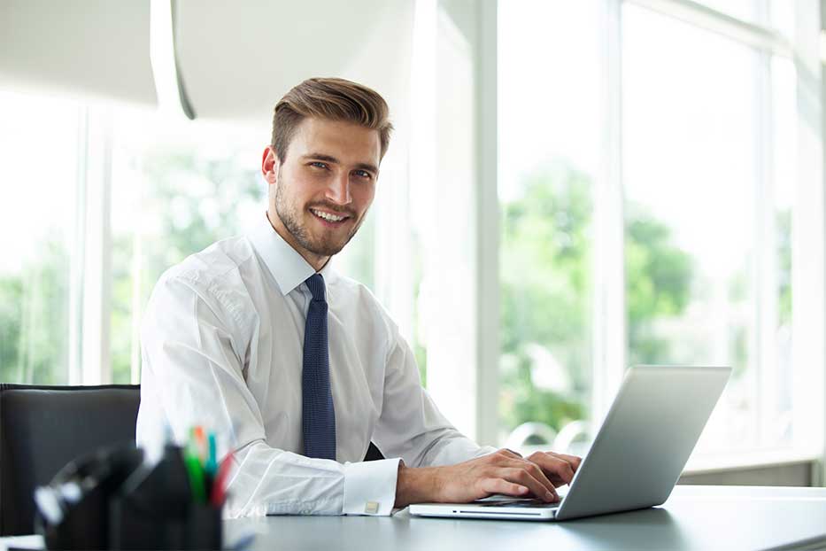 Man working on a laptop in an office,