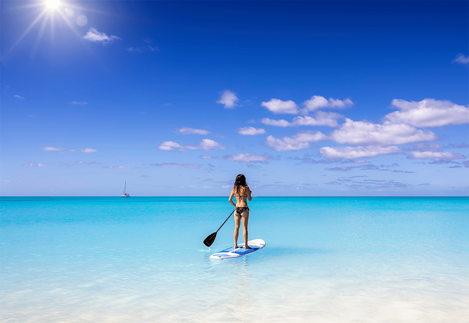 Lady Paddleboarding on Seven Mile Beach