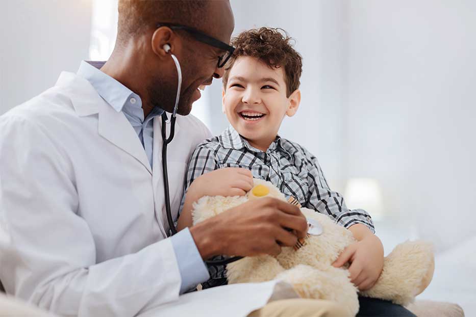 Cayman doctor laughing with young patient.