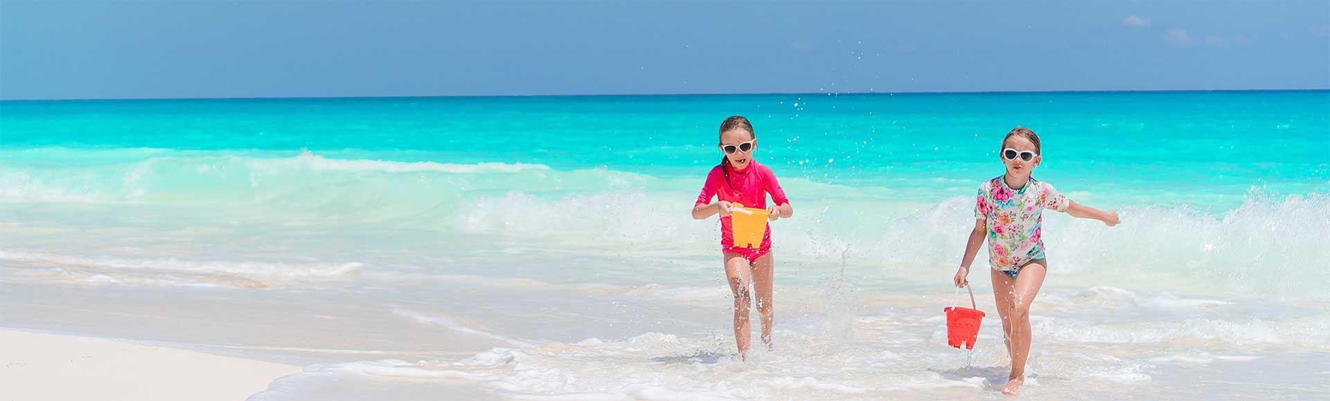 Two girls playing on the beach in the Cayman Islands