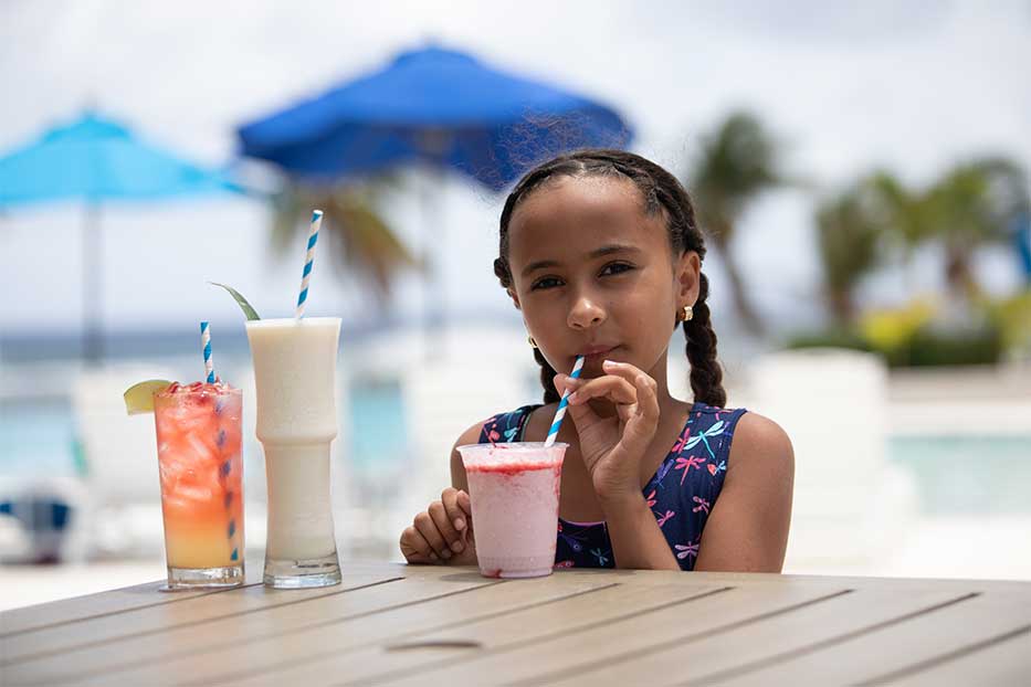 Young girl with a tropical smoothie in Cayman Brac