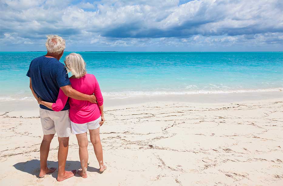 Couple on the beach enjoying retirement, Grand Cayman