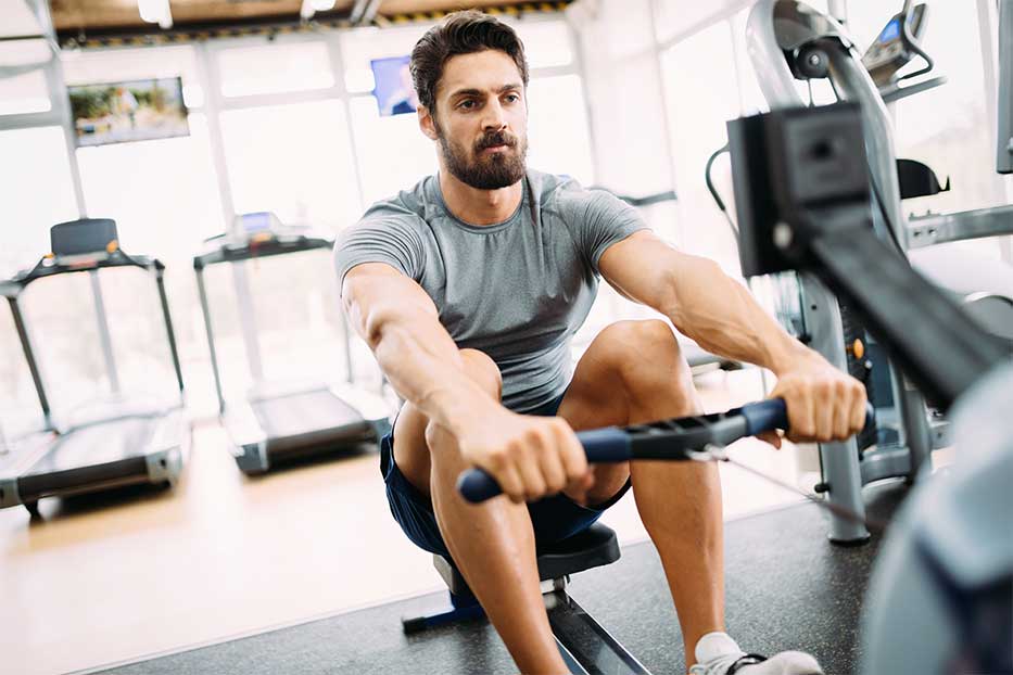Man in gym using a rowing machine