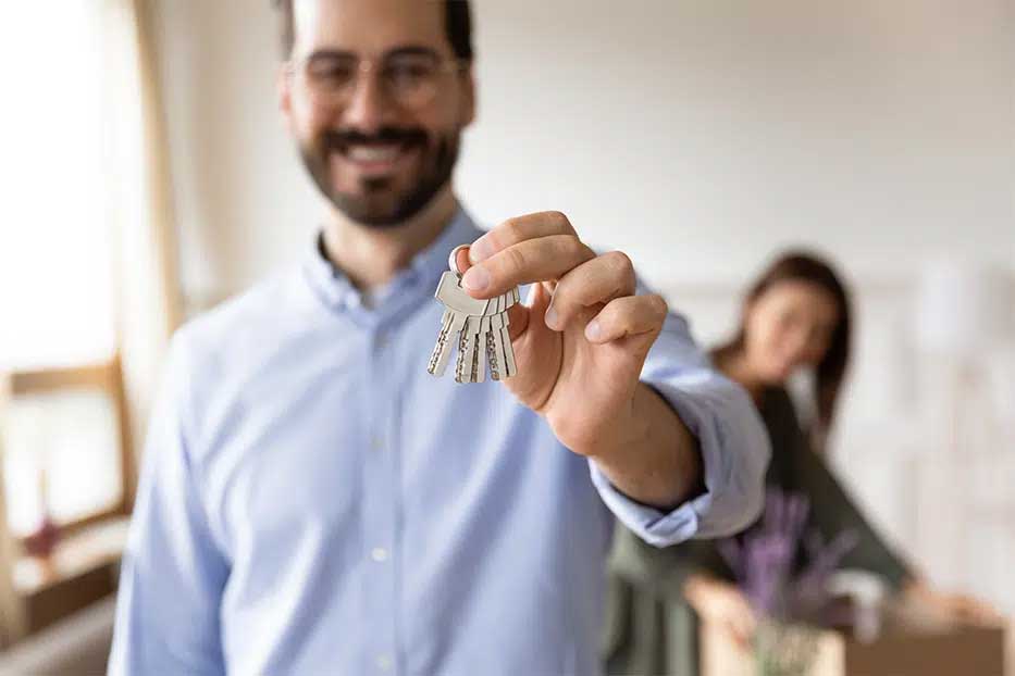 An estate agent handing over the keys to a new home in Grand Cayman.