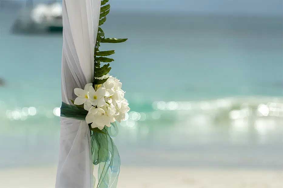 Close up of wedding flowers with Caribbean Sea in the background.