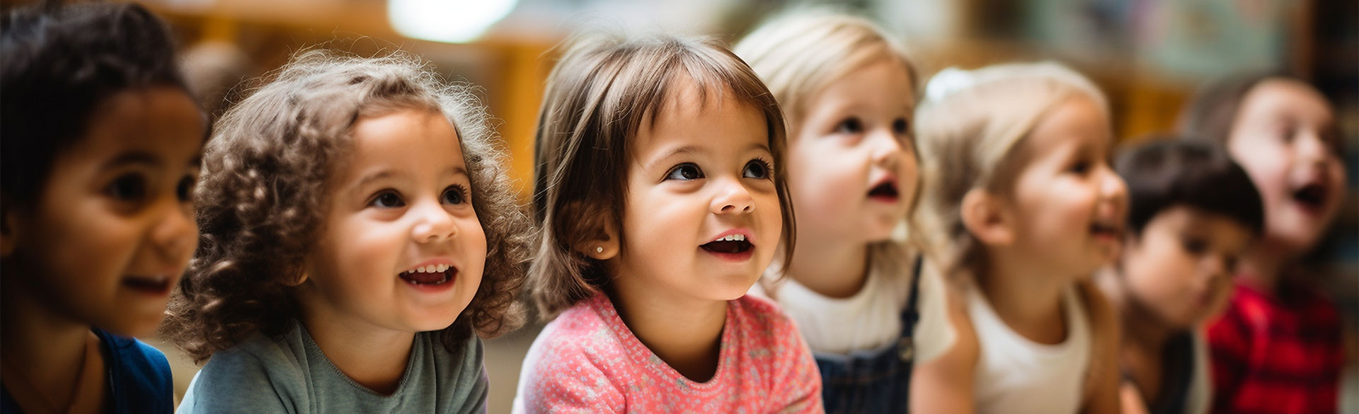 Nursery school aged children sitting in a row